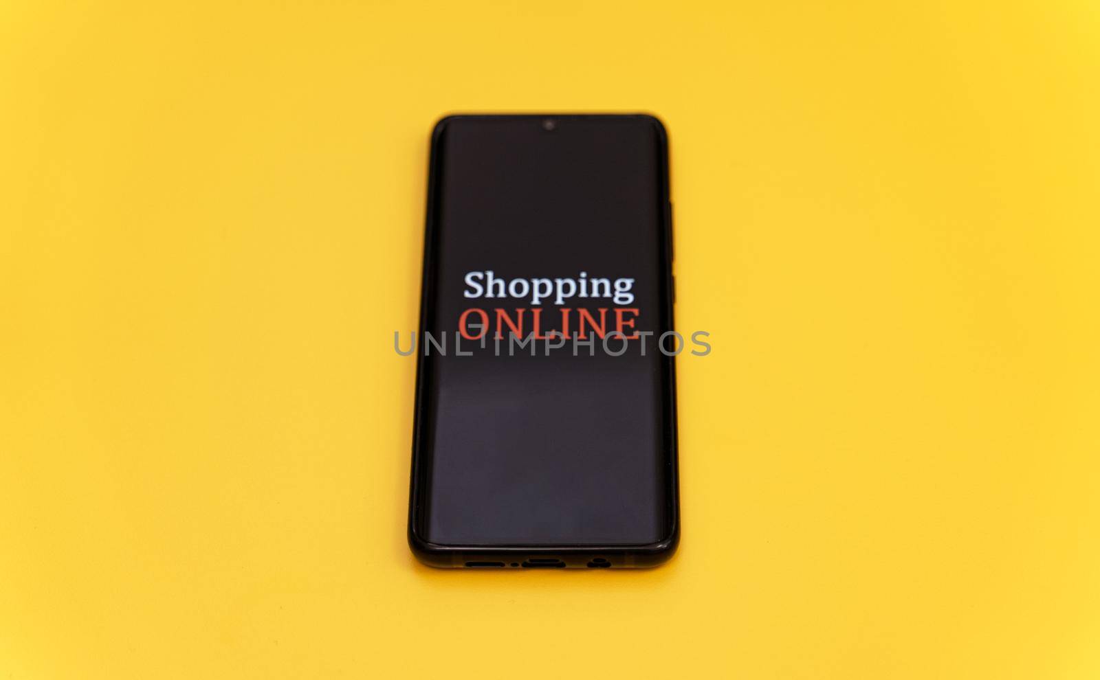 Smartphone on yellow background. Online shopping concept.