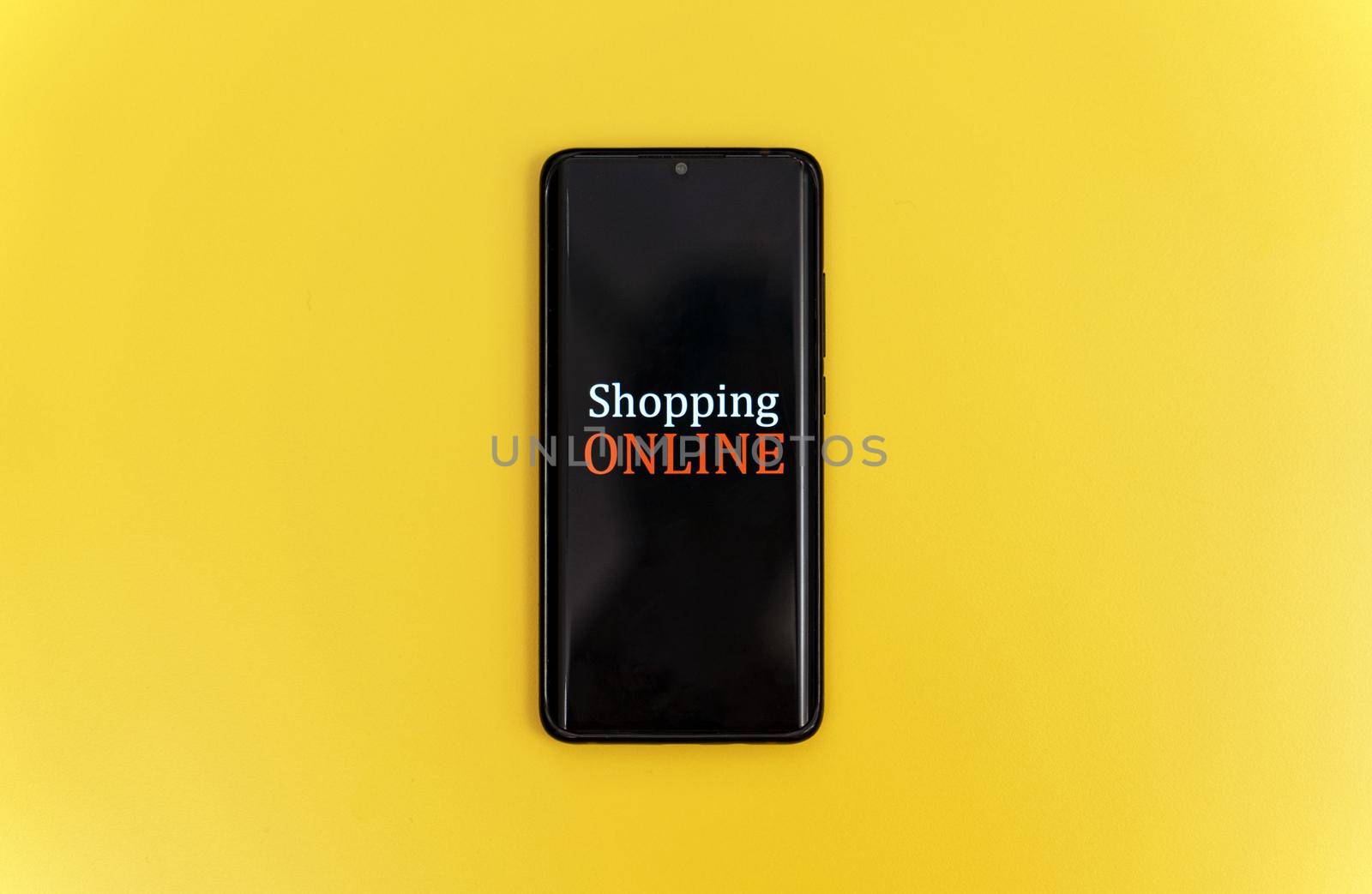 Smartphone on yellow background. Online shopping concept.