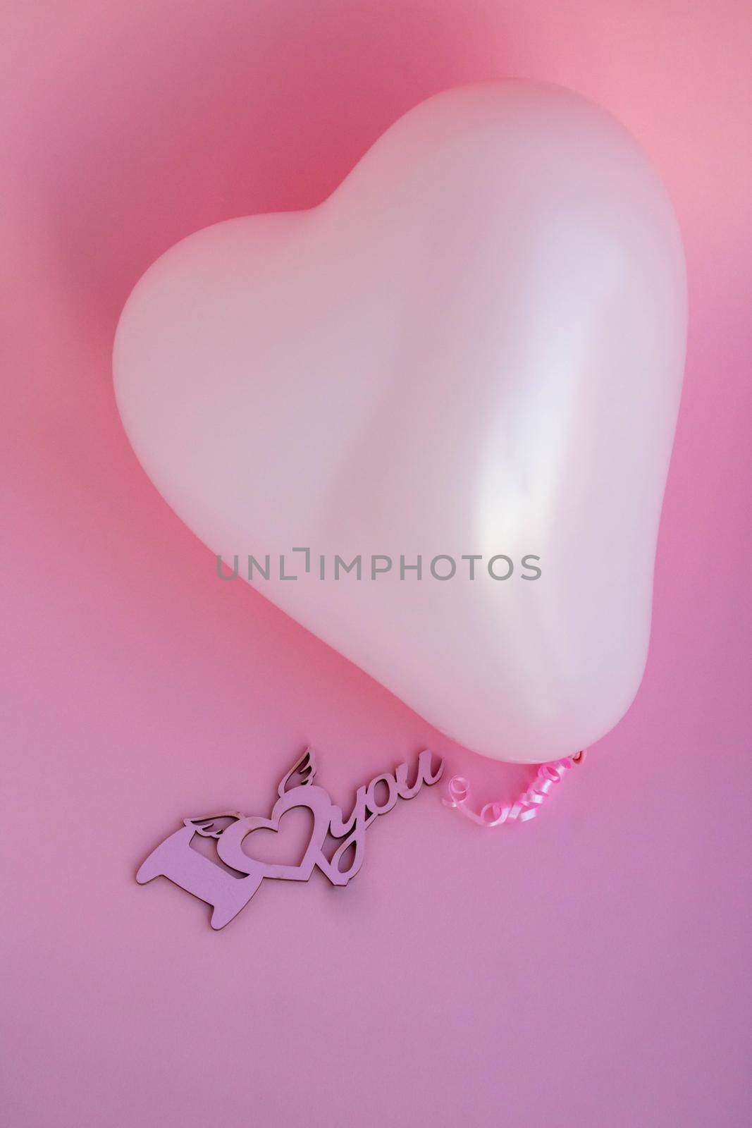 Pink balloon in the shape of a heart on a pink background, with a sign I love you. Wedding concept, Valentine's Day, photo zone, lovers. Banner. top view. Place for your text by lapushka62