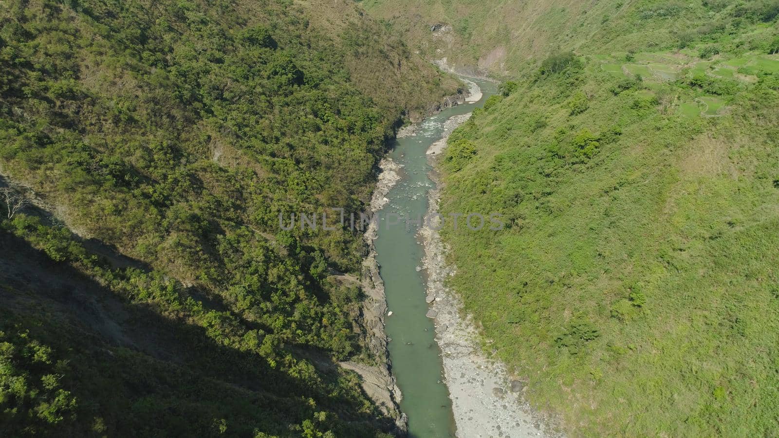 Aerial view of mountain river in the cordillera gorge, mountains covered forest, trees. Cordillera region. Luzon, Philippines. Mountain landscape.