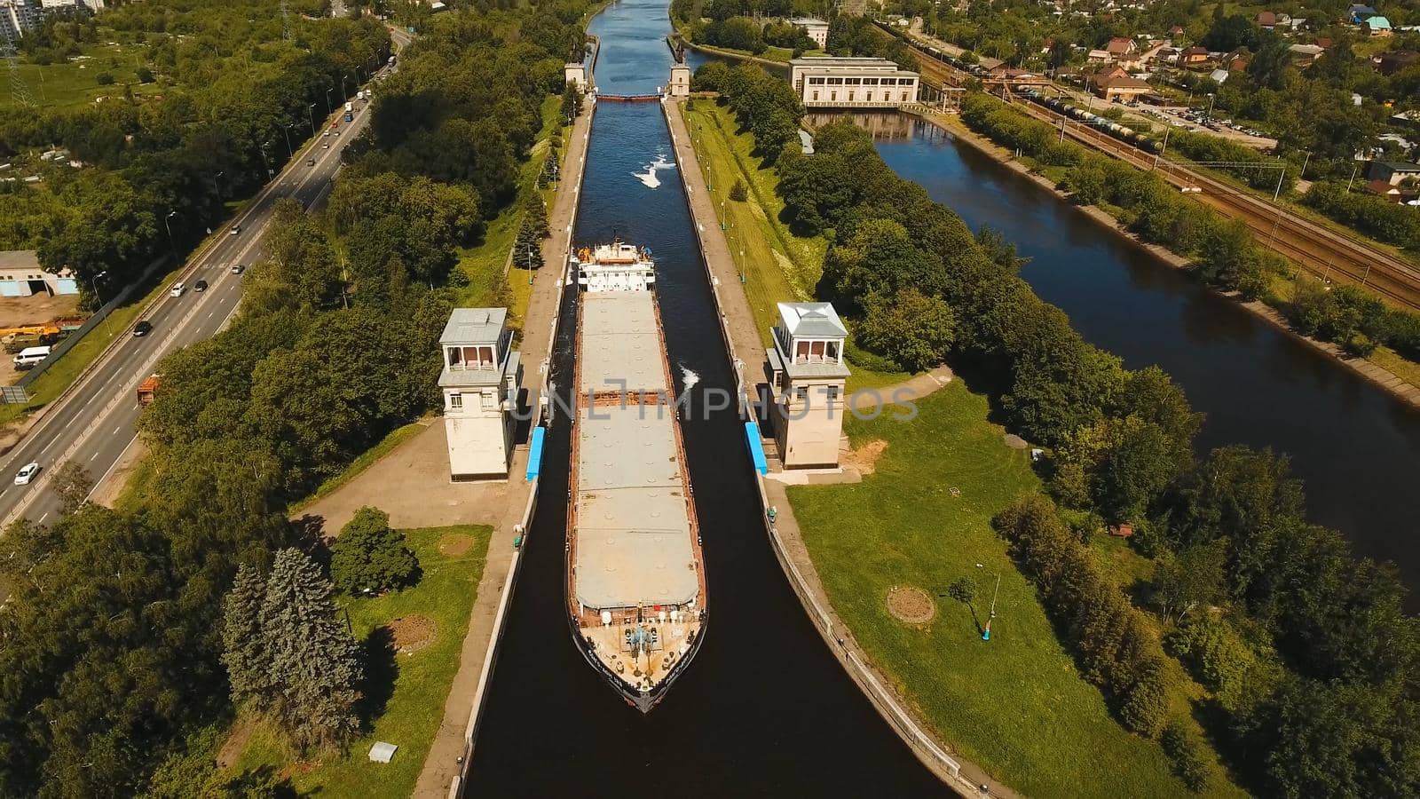 Sluice Gates on the River. Aerial view barge, ship in the river gateway. River sluice construction, water river gateway. Shipping channel.