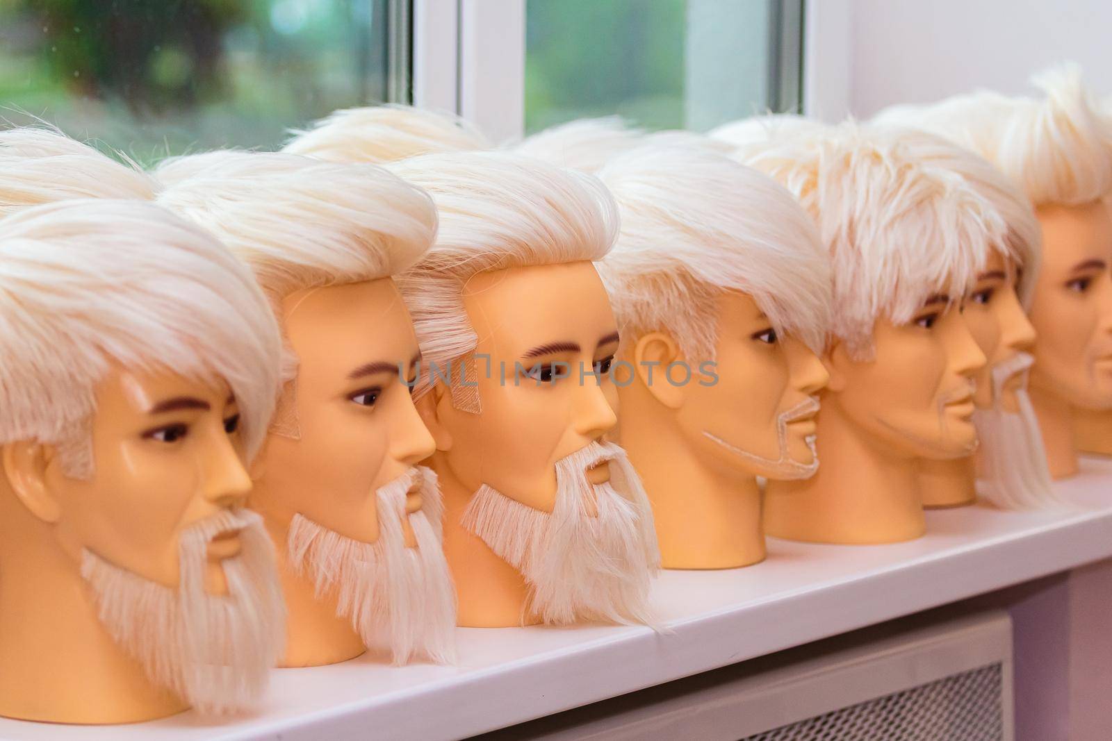 Male mannequins for training hairstyles. Male images with a beard and mustache, close-up.