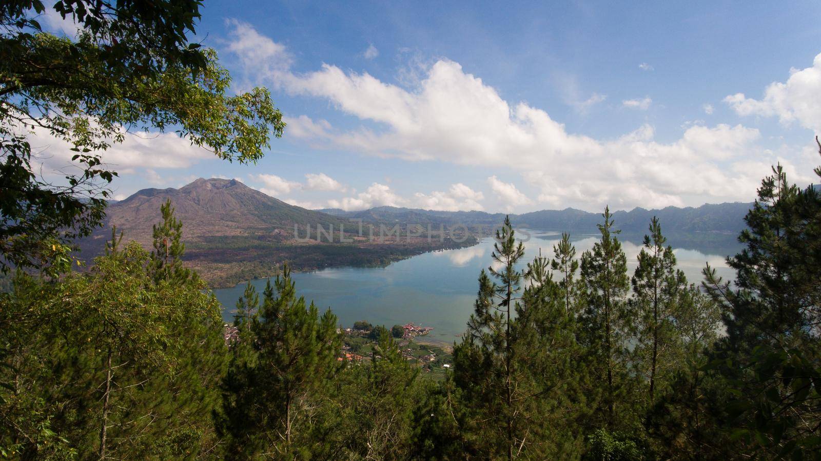Aerial view Mountains, volcanoes, crater lake Batur, Bali, Indonesia. Mountain landscape with volcanoes, lake, sky and clouds. Travel concept