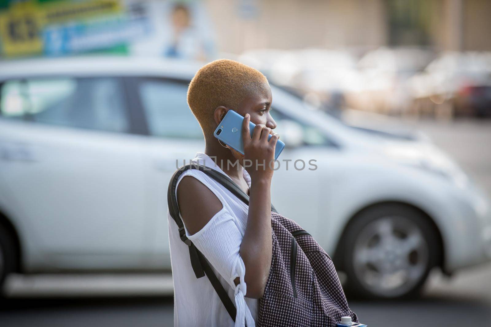 Ukraine. The city of Kharkov. September 10, 2019. A dark-skinned girl is talking on the phone. Girl with a dark skin color. by Yurii73
