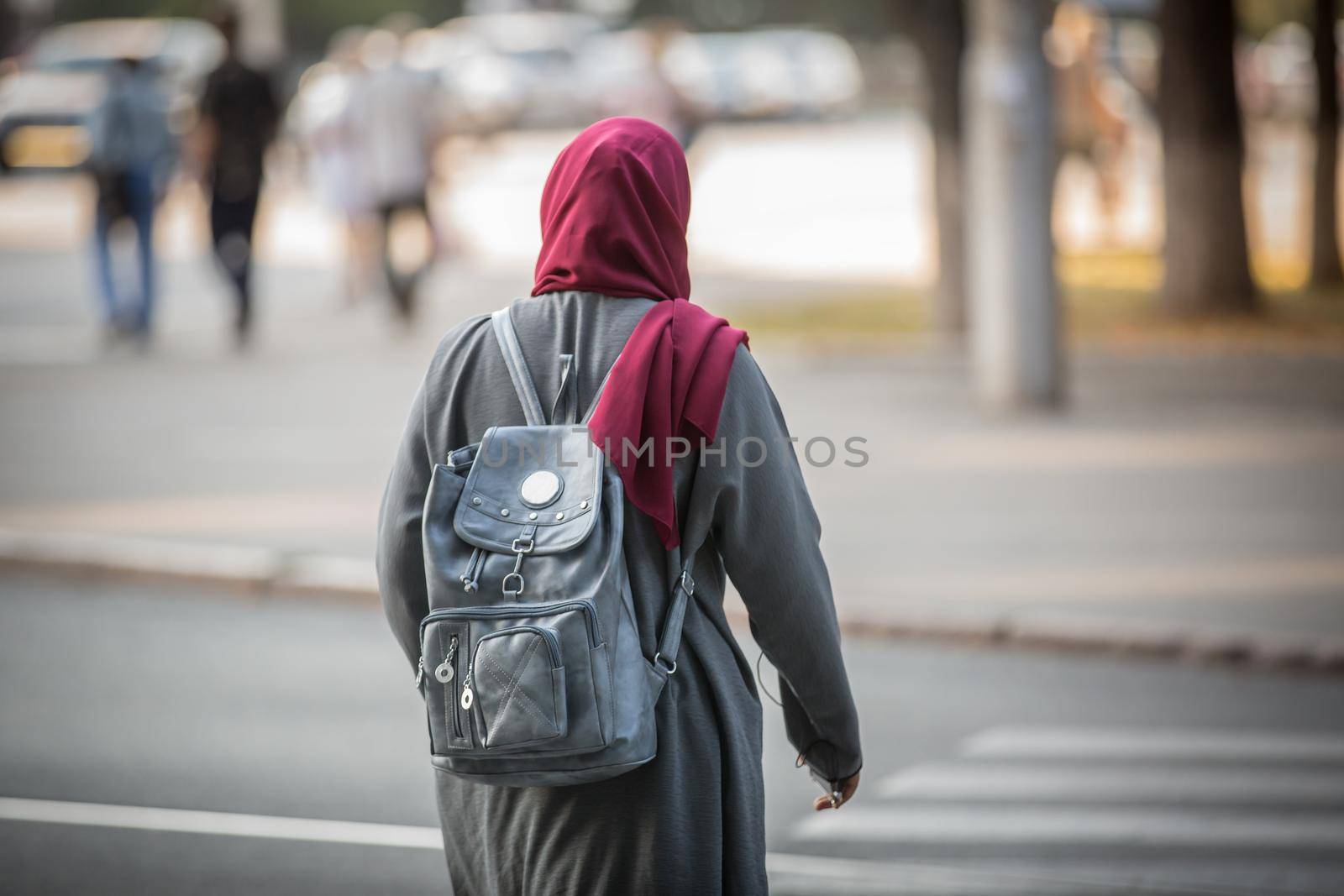 A girl of Arab appearance walks around the city. European student from an Arab country.