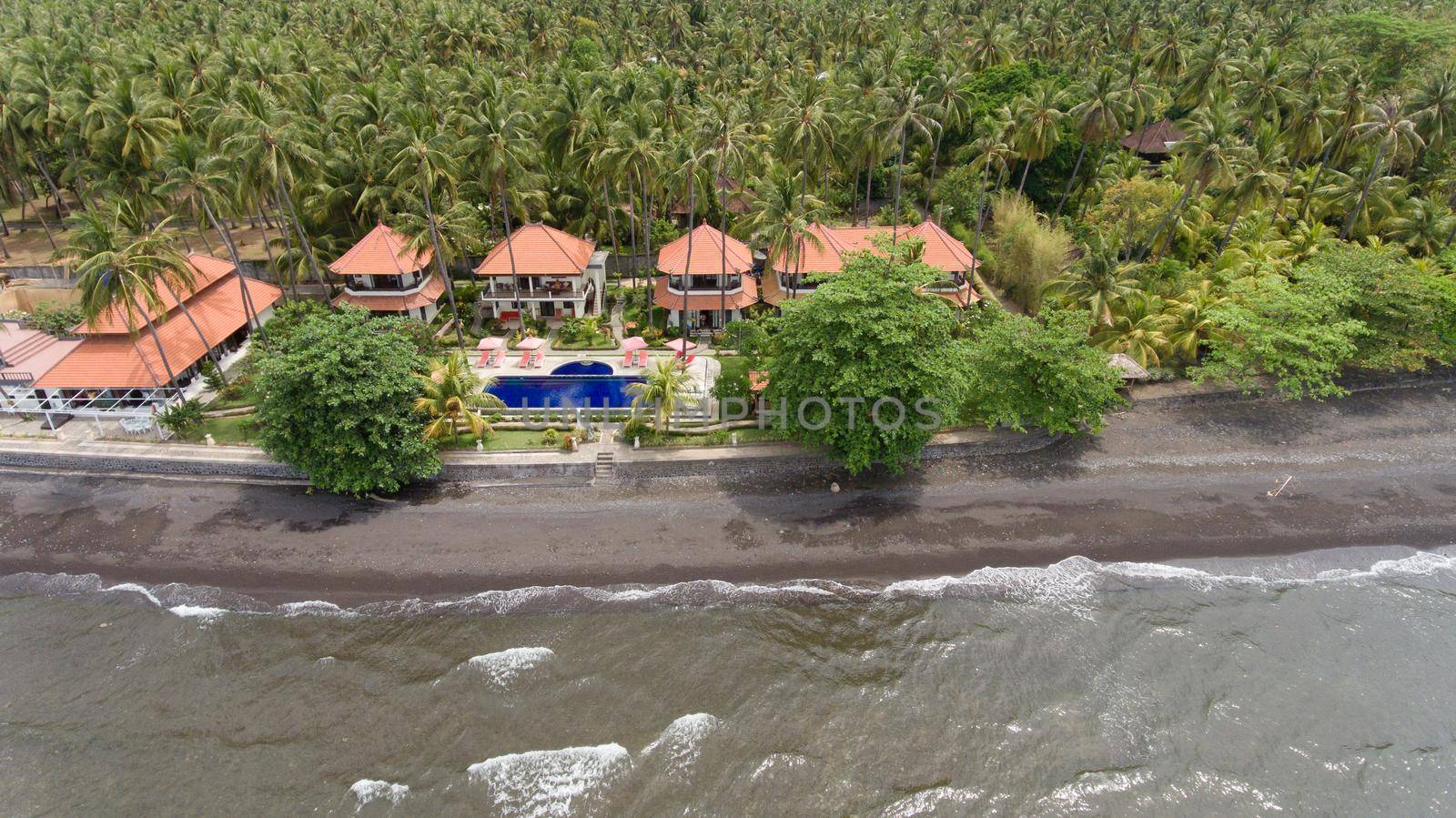 Aerial view of beautiful beach, hotel, Bali, Indonesia. Beach with black volcanic sand.Seascape ocean, sky, sea. 4K video Travel concept, Aerial footage.