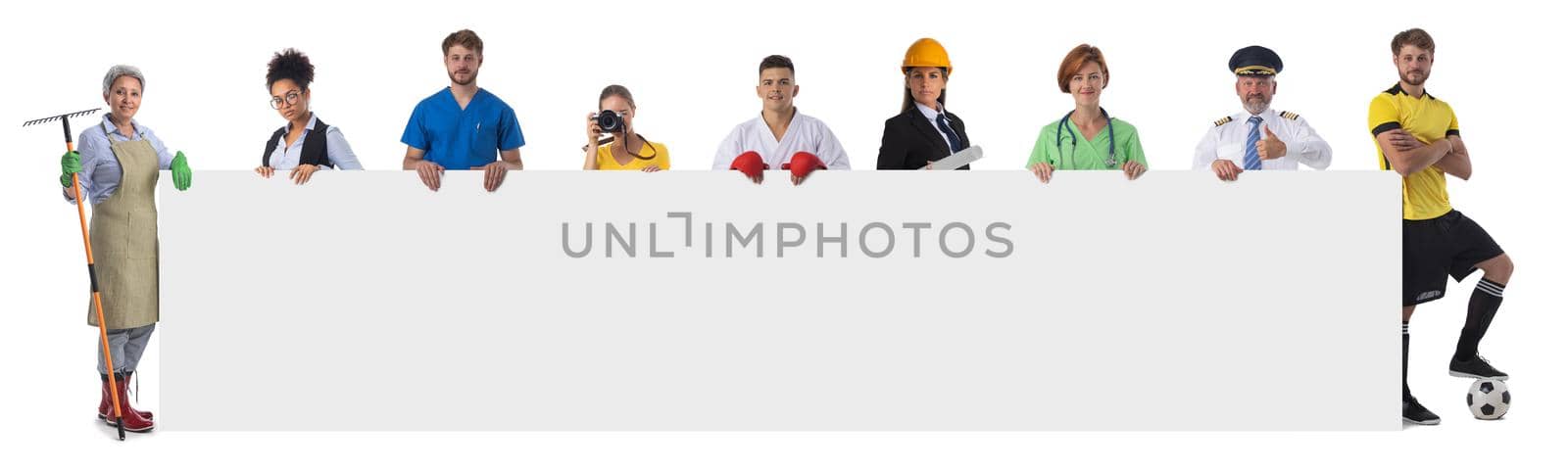 Group of diverse professionals holding blank banner ad isolated on white background