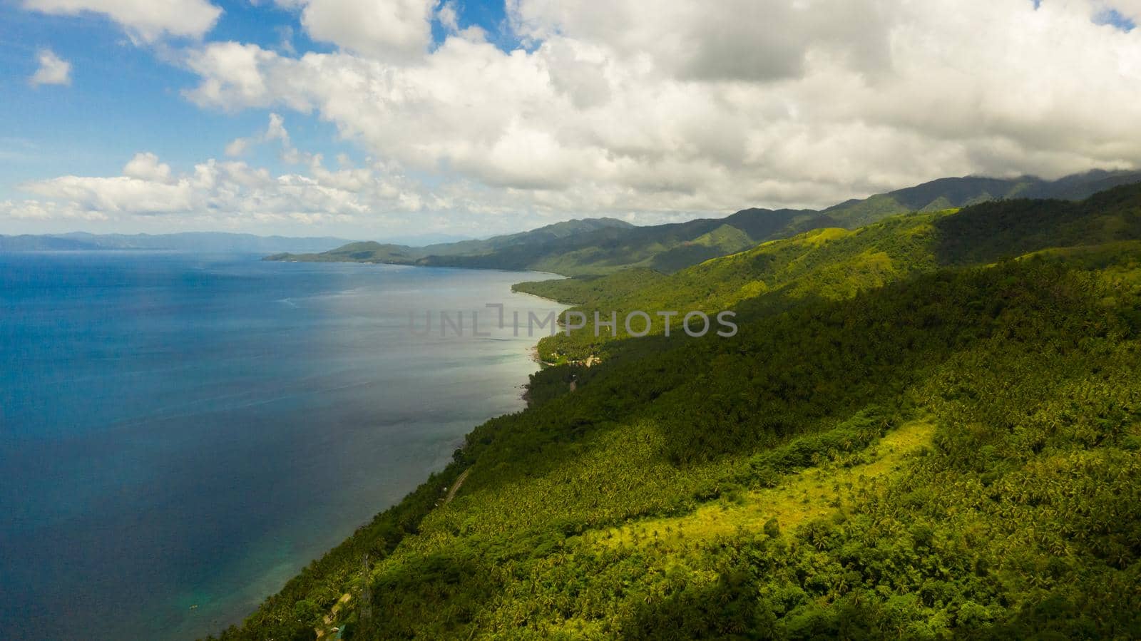 Tropical landscape: Leyte island with mountains covered with tropical green forest and blue sea. Seascape, Philippines.