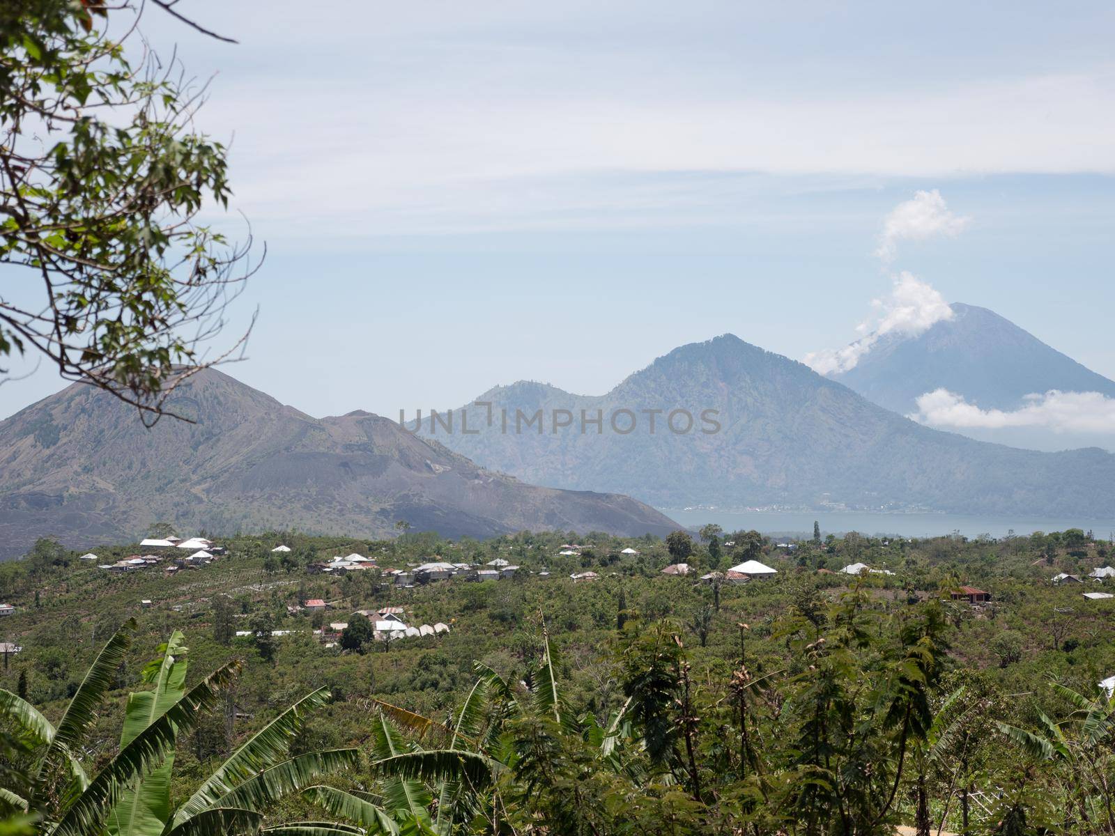 Aerial view crater lake Batur, volcanoes Batur, Agung. Bali, Indonesia. Mountain landscape with volcanoes, lake on the background of the sky and clouds. Travel concept.
