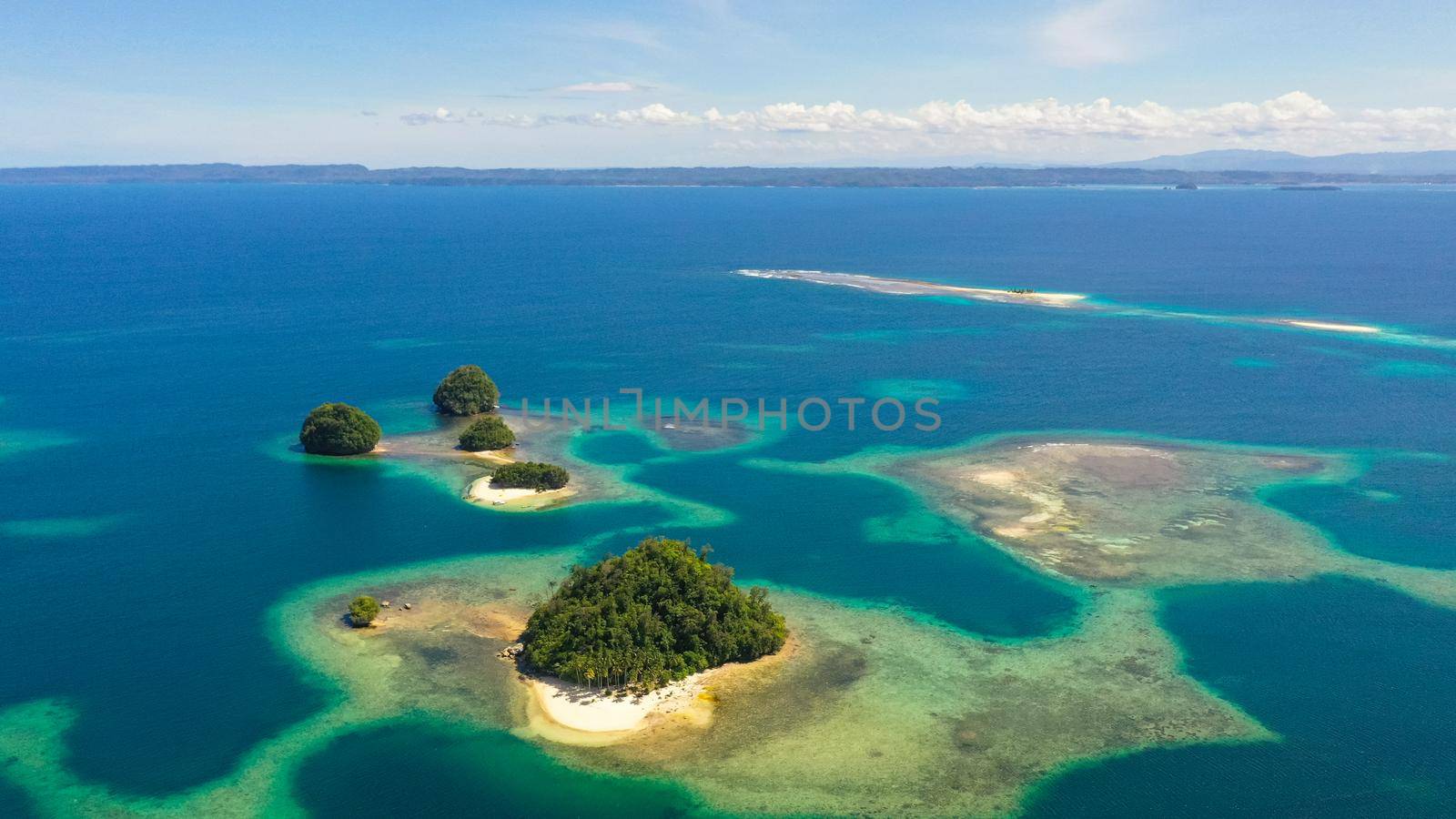 Aerial view of sandy beach on a tropical island with palm trees. Britania Islands, Surigao del Sur, Philippines.