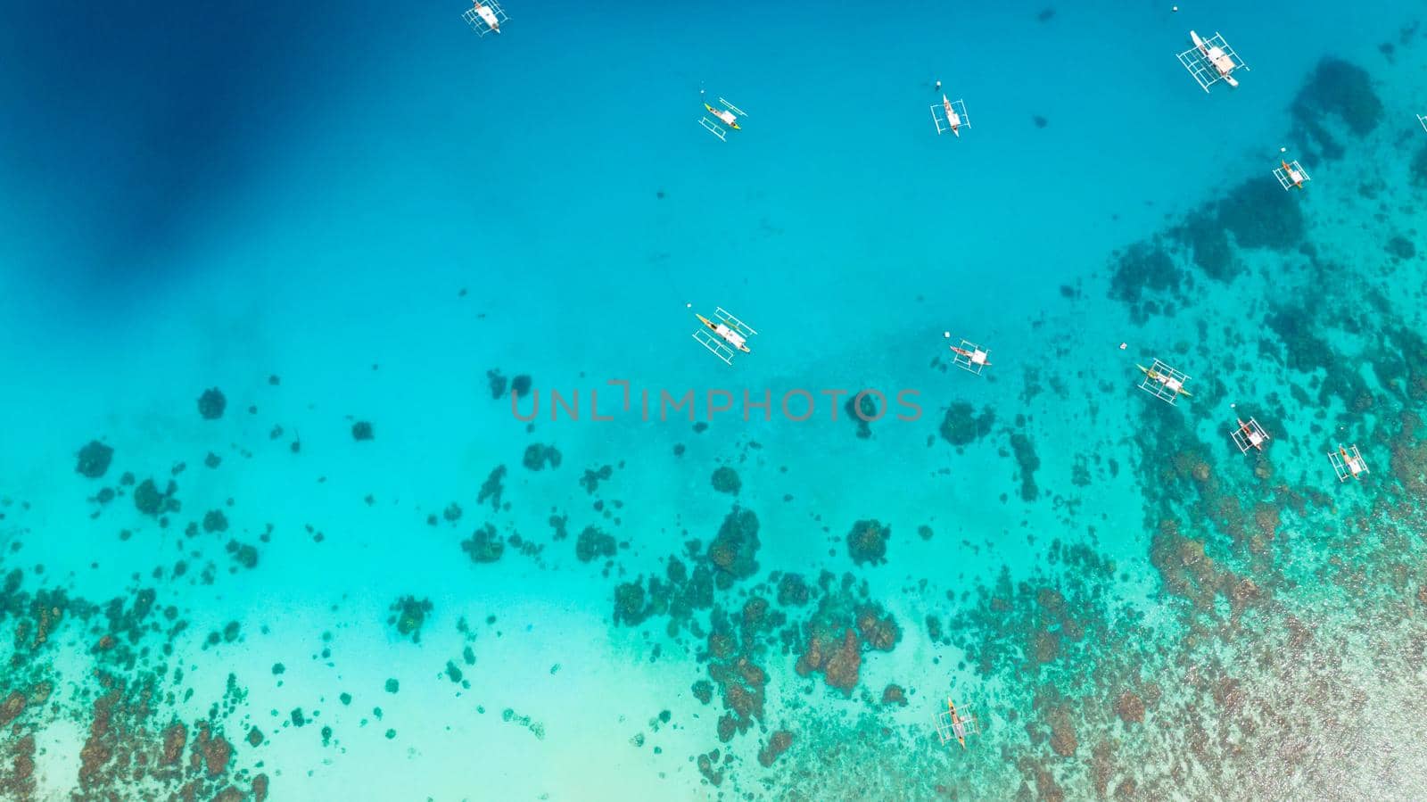 Beautiful beach, palm trees by turquoise water view from above. Alorro Beach, Philippines, Samal.
