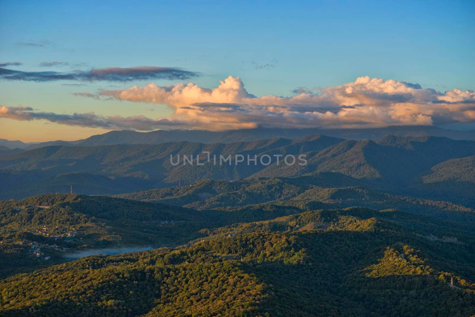 Natural landscape with mountain peaks under the blue sky.