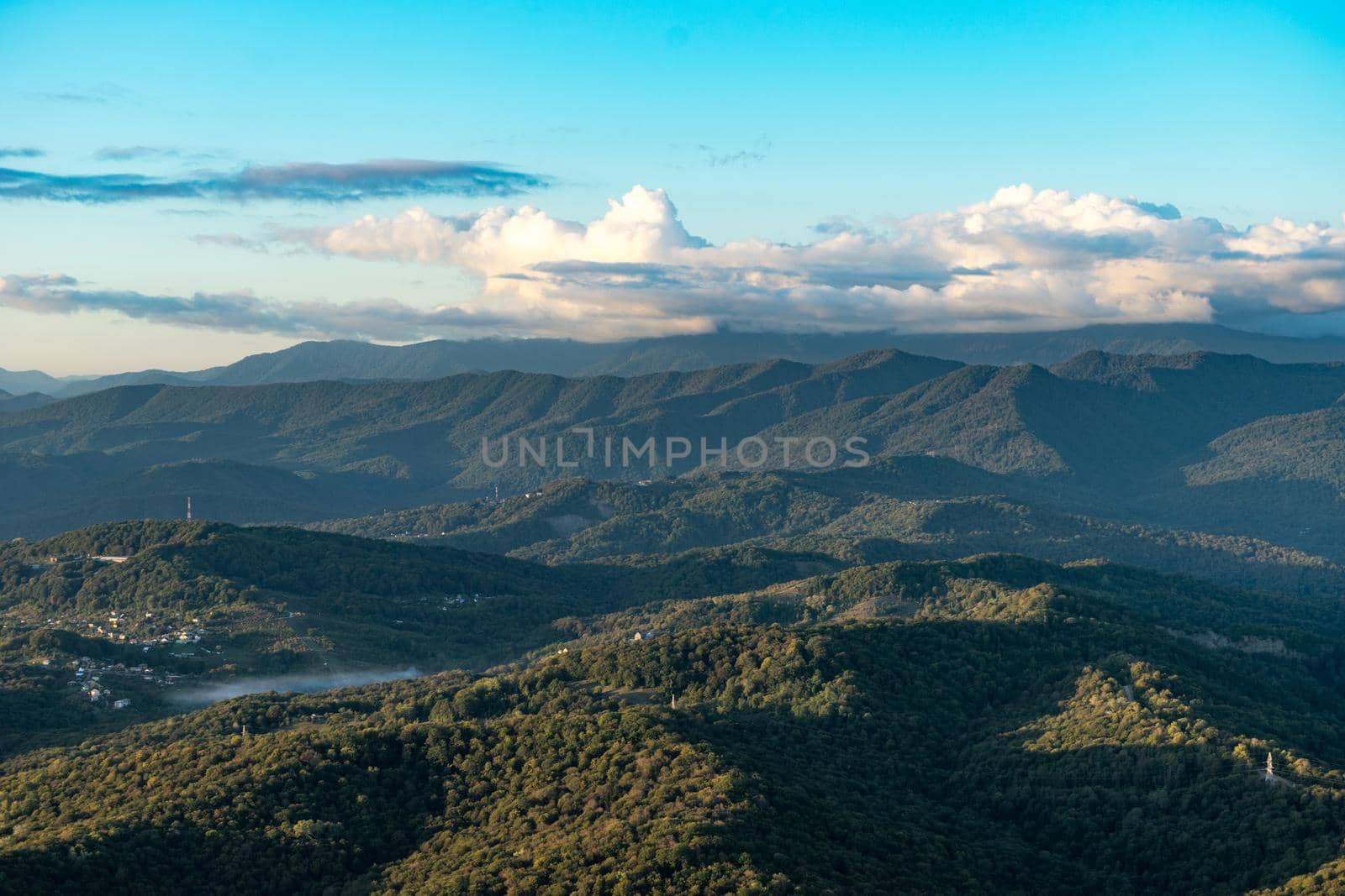 Natural landscape with mountain peaks under the blue sky.