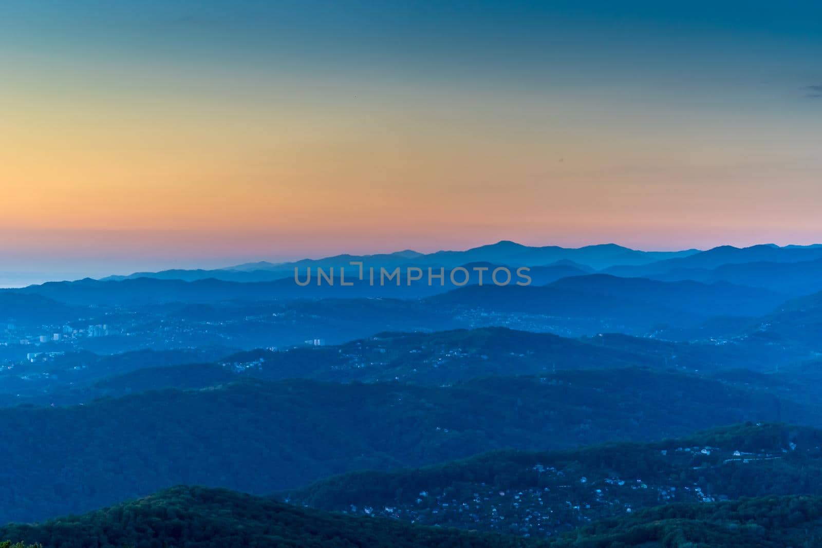 Sochi, Russia. Mountain landscape with several rows of hills at sunset.