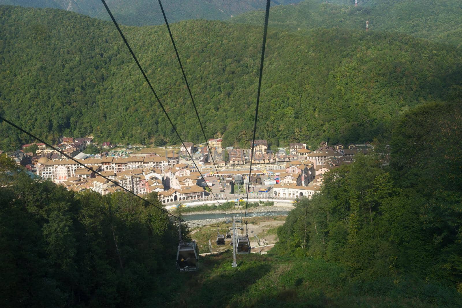 mountain landscape on the background of blue sky with clouds with the types of cable car