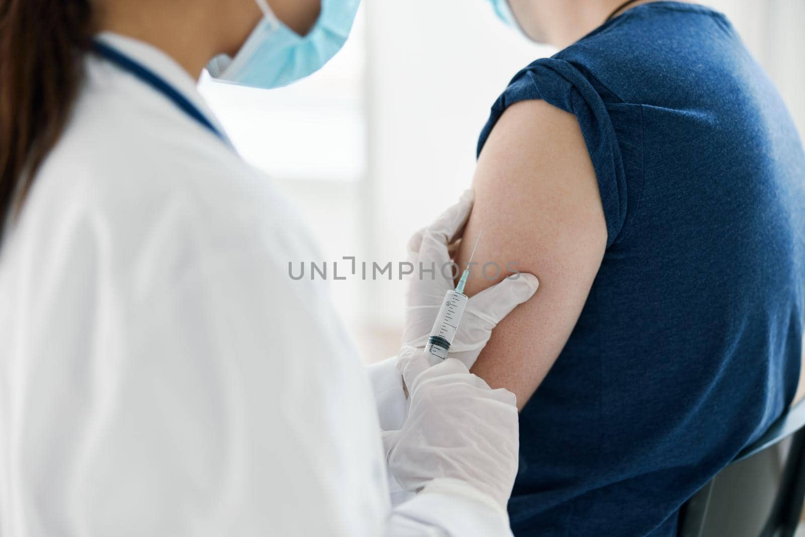 woman doctor nurse in protective gloves and coronavirus vaccine injection epidemic. High quality photo