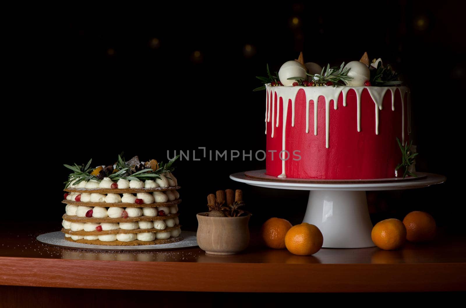 Homemade tasty whole round cake with white cream, black cookies on black wooden background