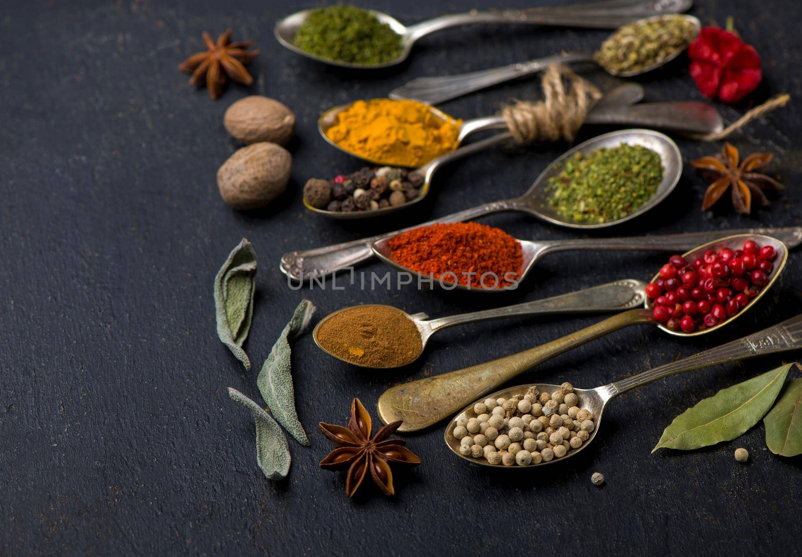 Various spices spoons on table. Top view with copy space