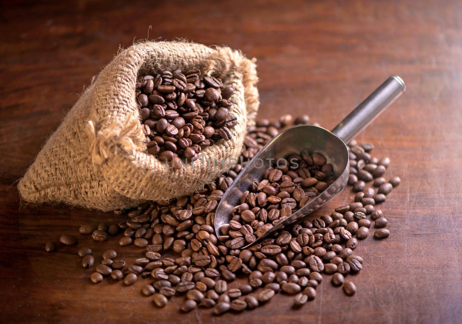cup of coffee and coffee beans in a sack on dark background, top view by aprilphoto