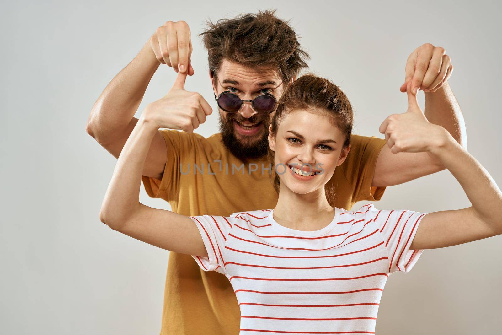 Young couple socializing romance lifestyle fashion fun light background by SHOTPRIME