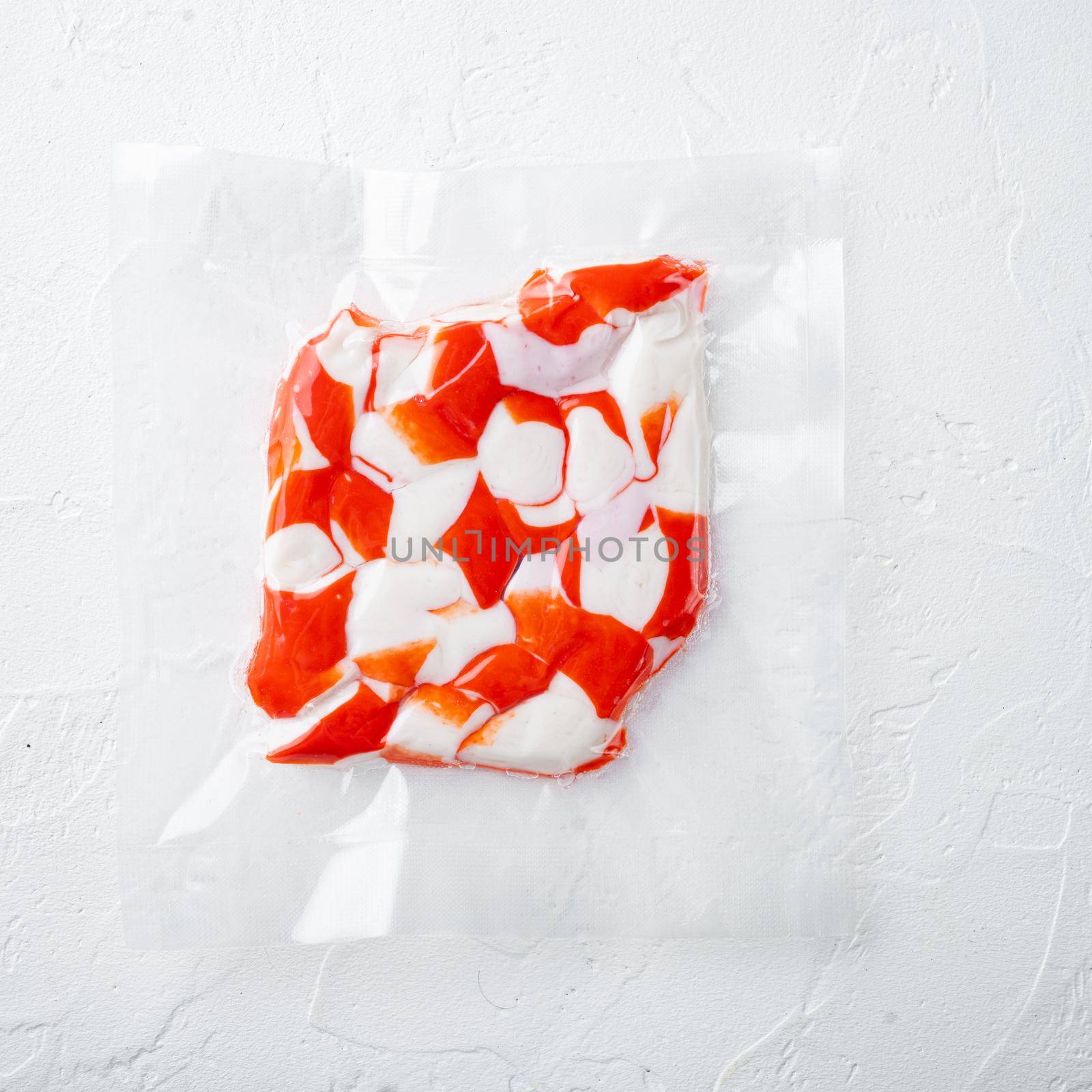 Crab meat surimi vacuum pack, on white background, top view flat lay by Ilianesolenyi