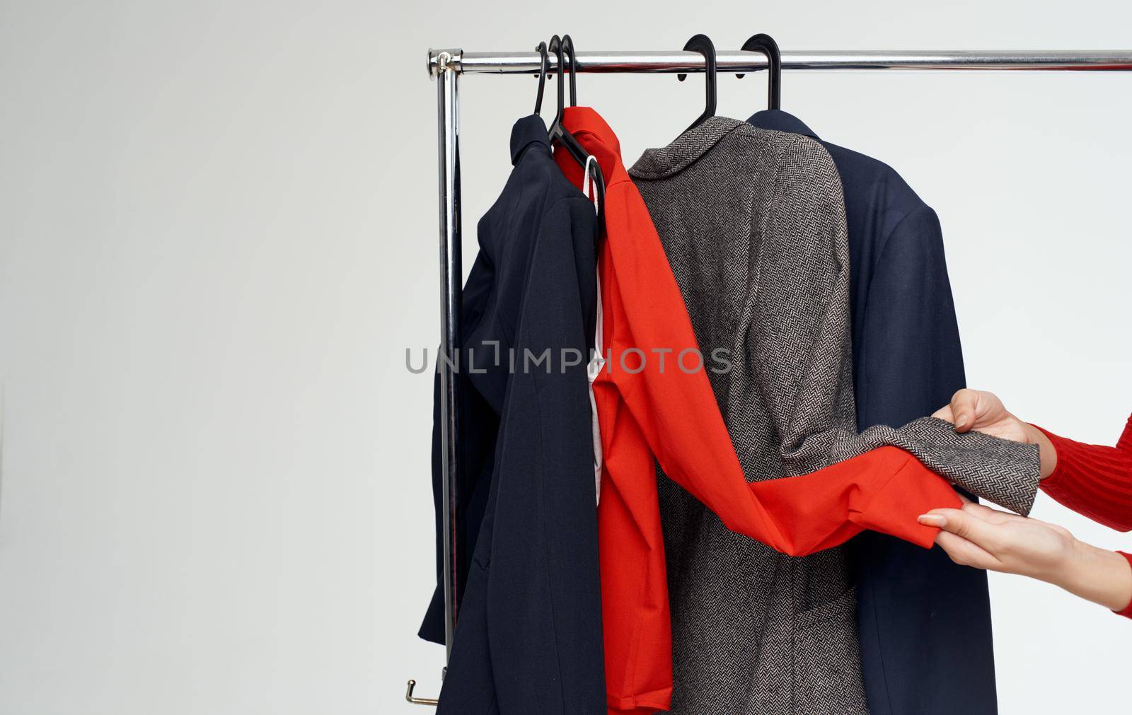 Woman dressing room near fashionable clothes on a light background jacket suit by SHOTPRIME