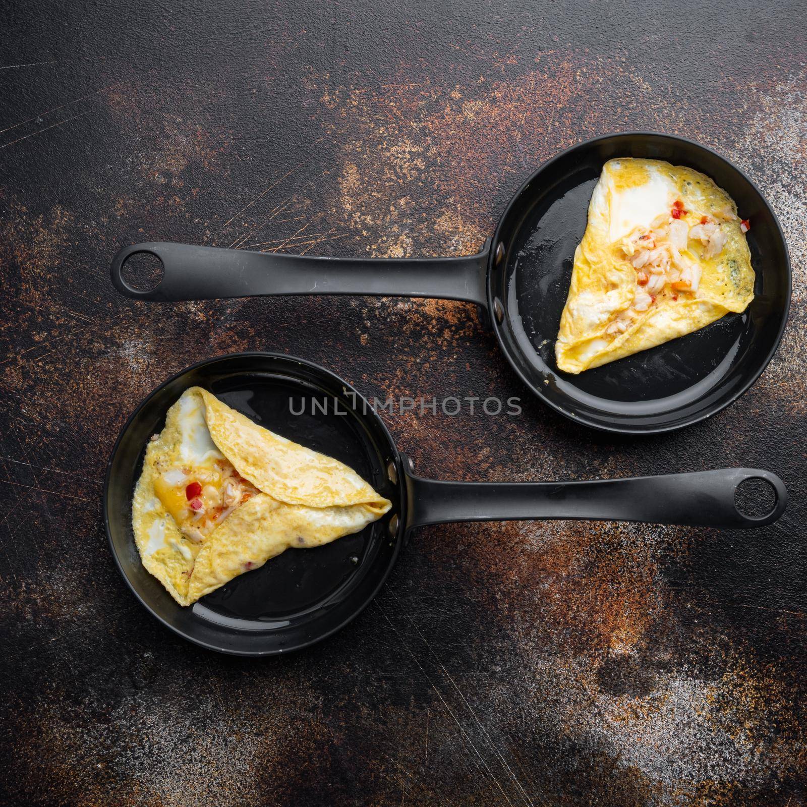 Chilli crab silky omlette , on frying iron pan, on old dark rustic background, top view flat lay by Ilianesolenyi