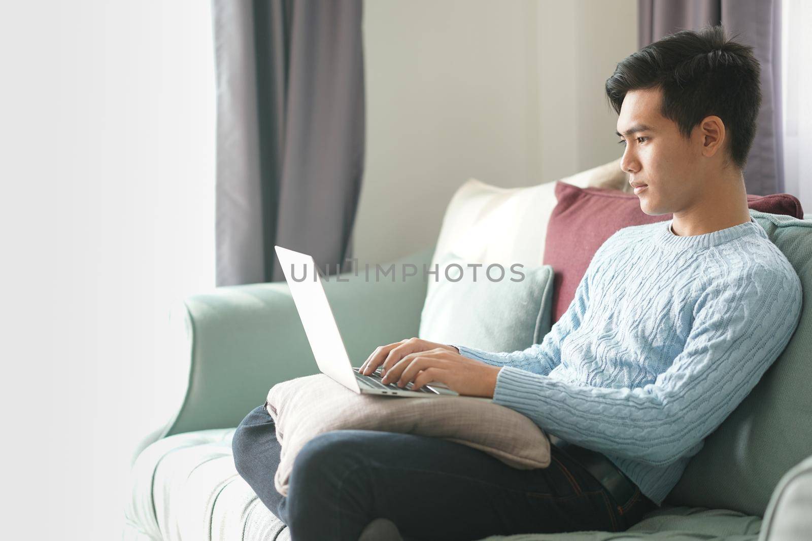 asian young teenage student man teenager entrepreneur working with computer studying learning online at home. e-learning webinar meeting. social distance in covid pandemic