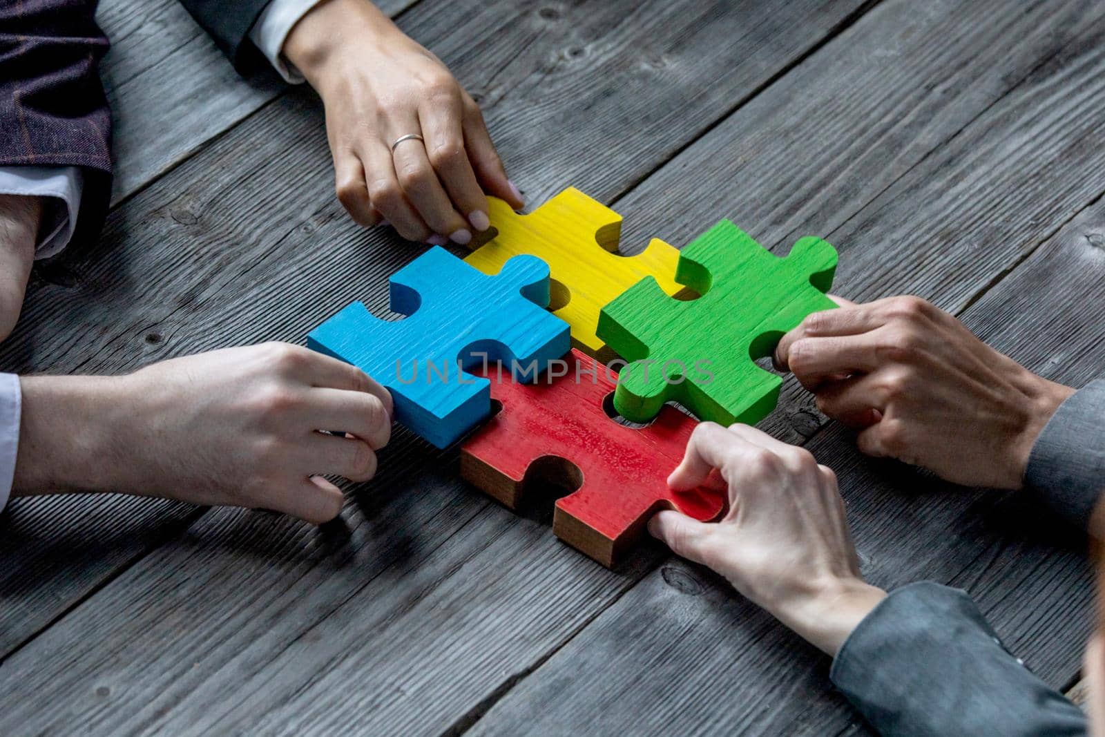 Business teamwork with puzzle by ALotOfPeople