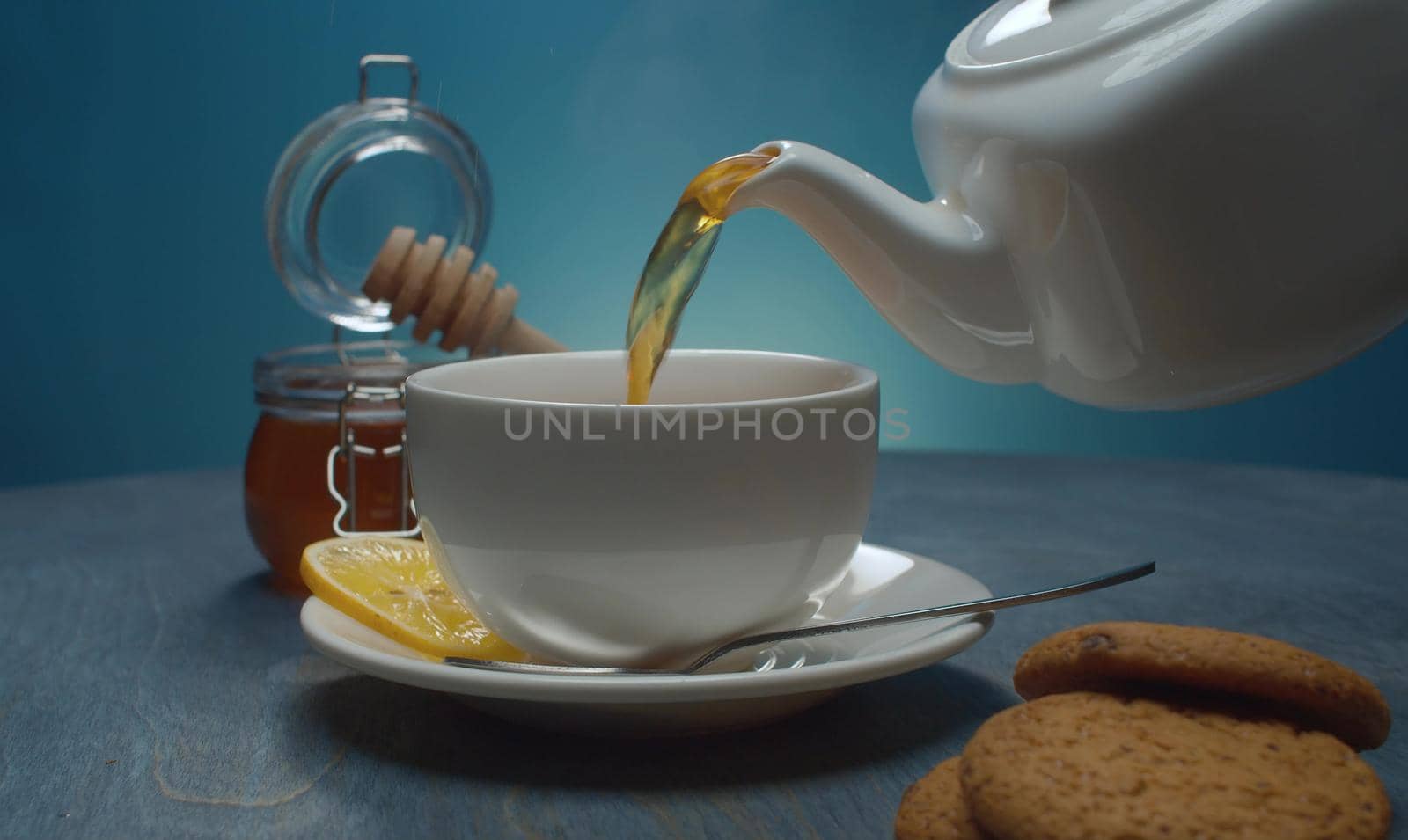 Hot tea pouring into the cup by Alize