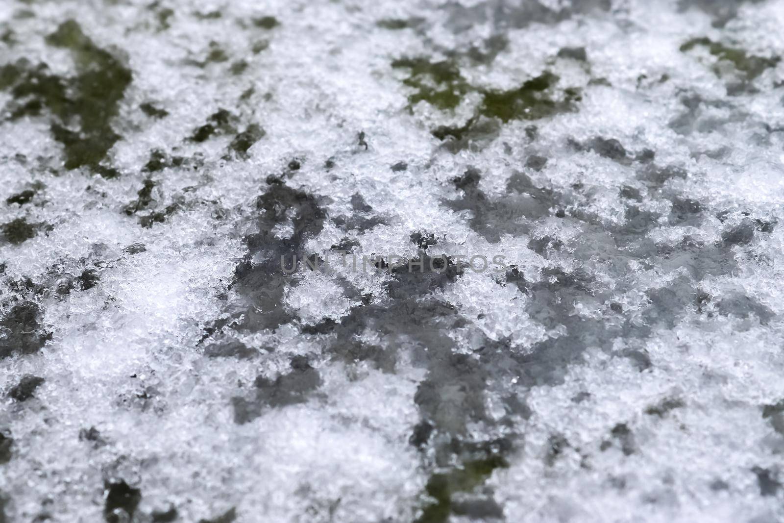 Dirty tracks of snow on asphalt on a small german road by MP_foto71