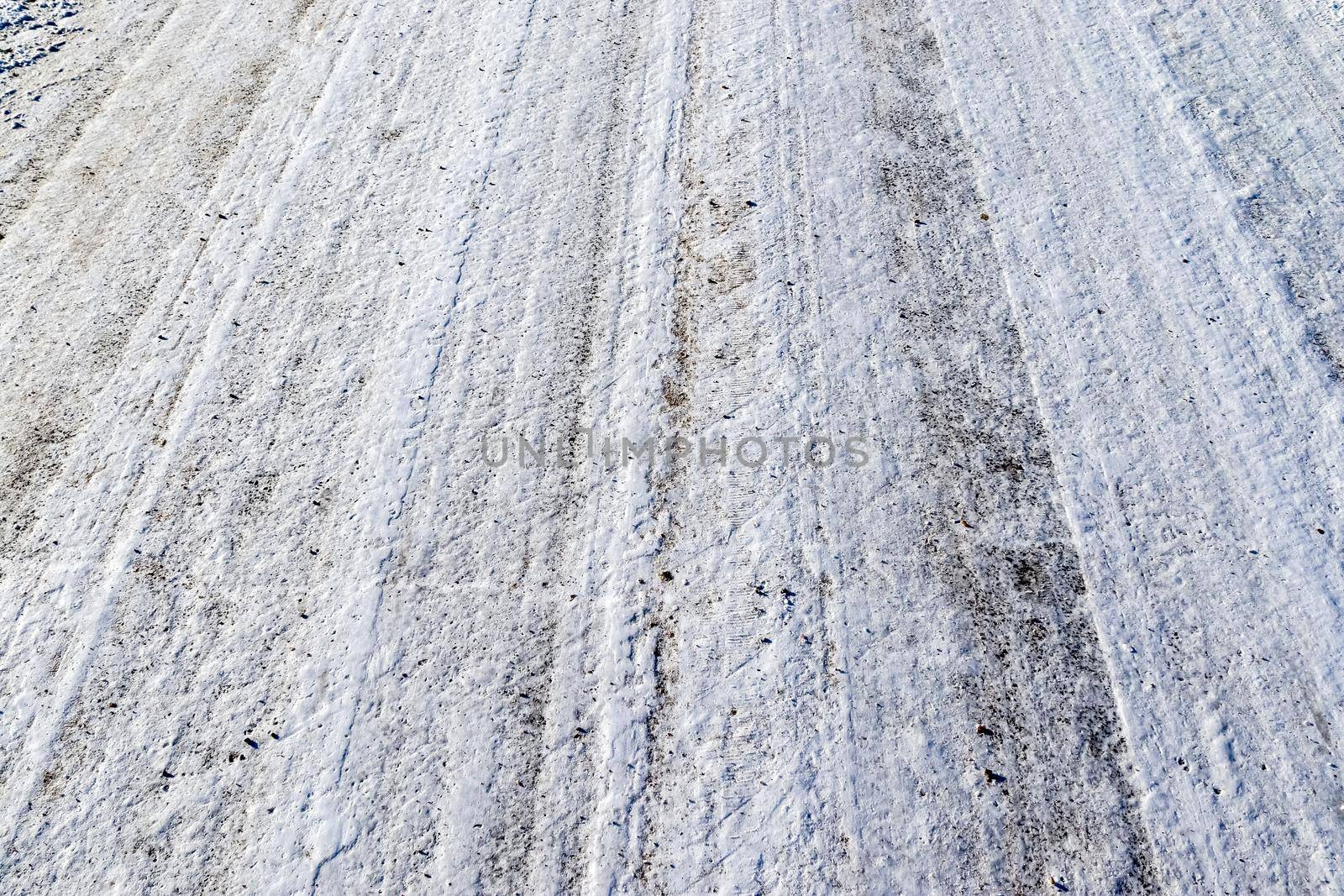 Tire Tracks on snow covered streets in a close up view