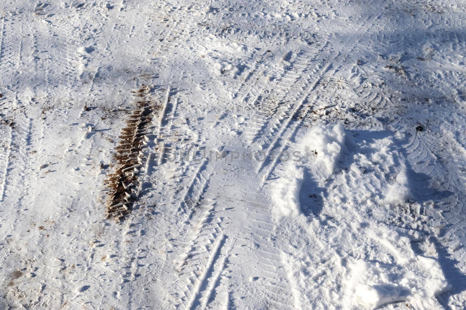 Tire Tracks on snow covered streets in a close up view