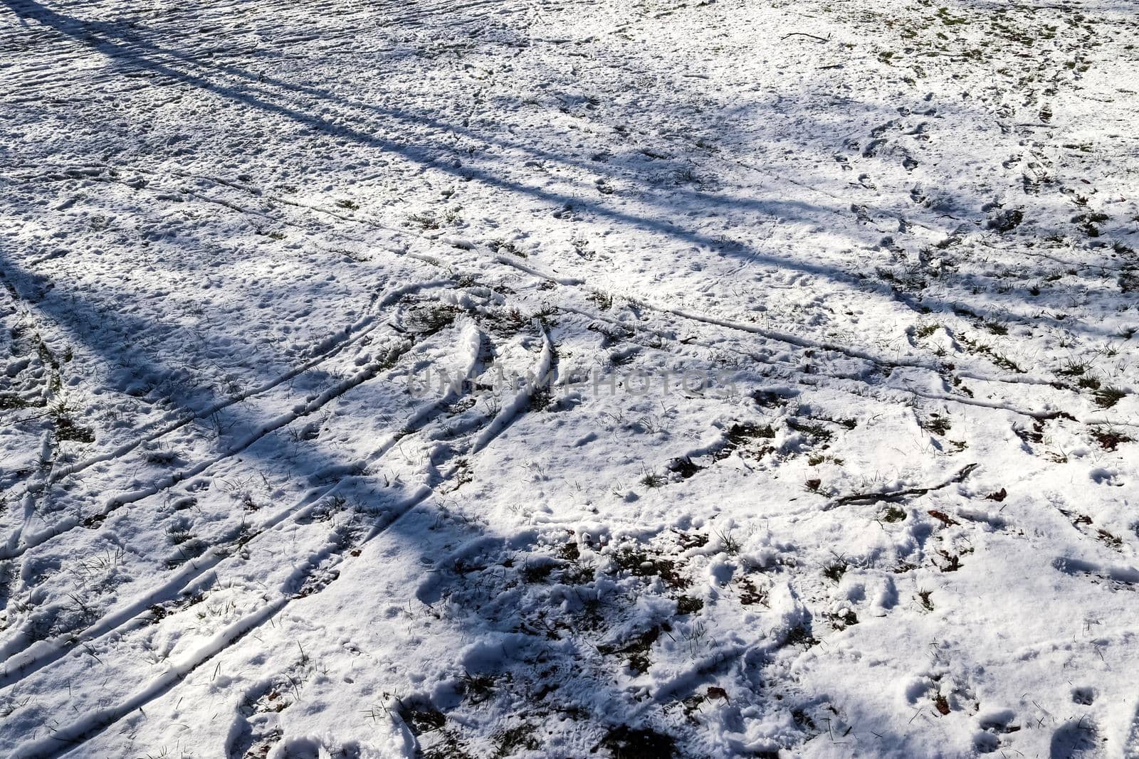 Footsteps of male shoes in fresh white snow in winter.