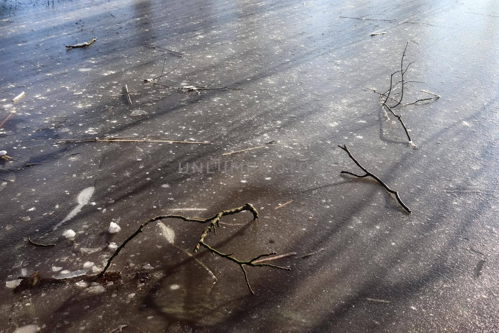 Snow covered frozen lake landscape in northern europe on a sunny day