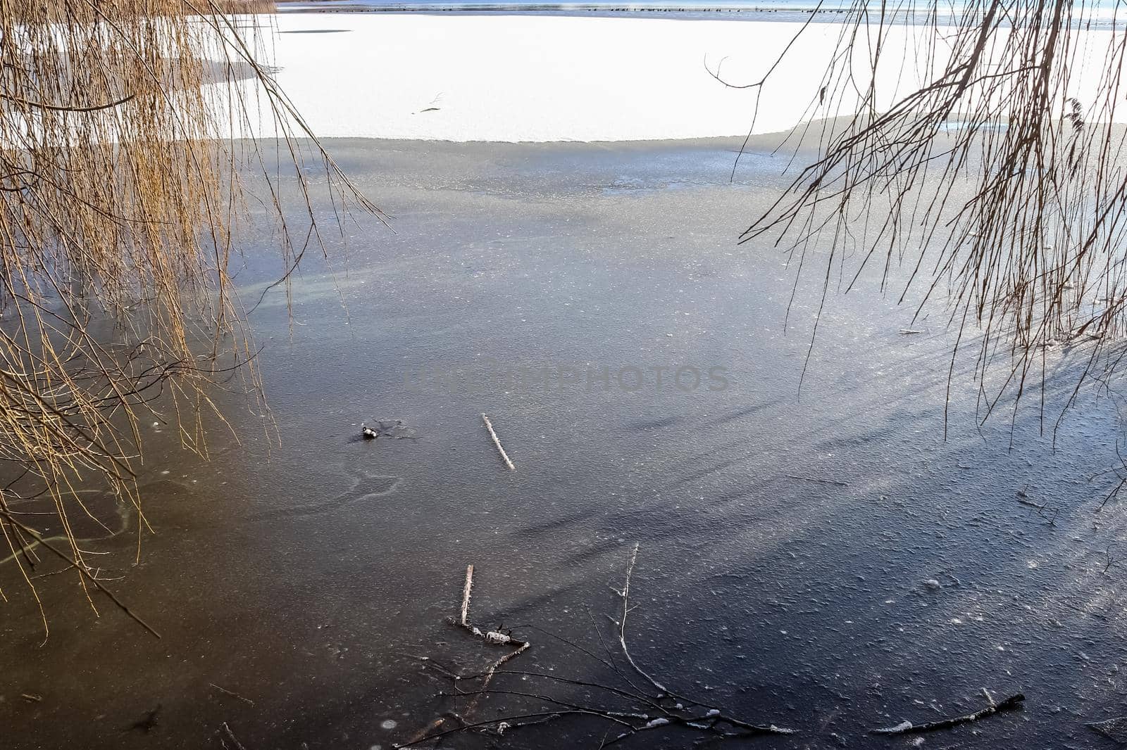 Snow covered frozen lake landscape in northern europe on a sunny day