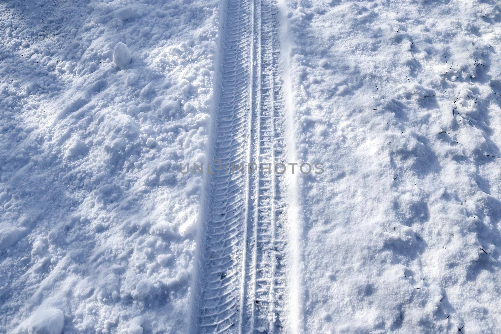 Tire Tracks on snow covered streets in a close up view