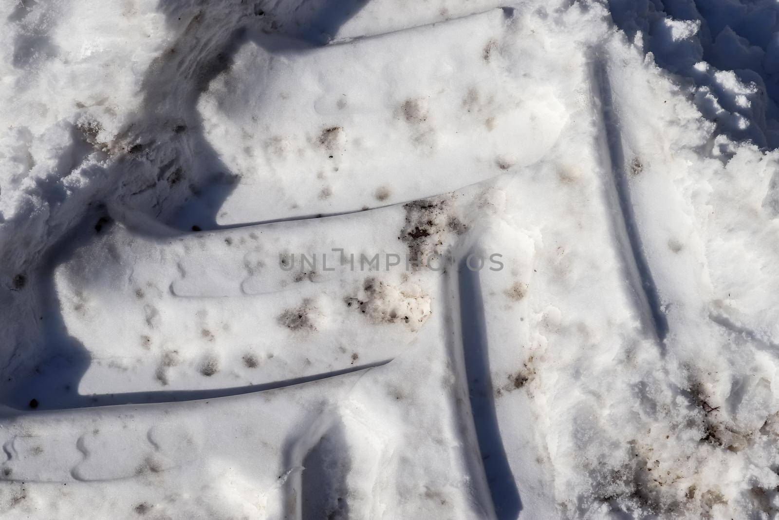 Tire Tracks on snow covered streets in a close up view