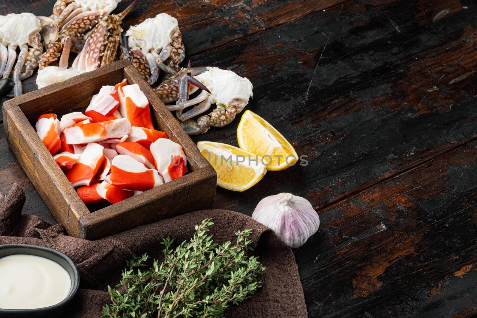 Asian snack surimi set, in wooden box, on dark wooden background , with copyspace and space for text