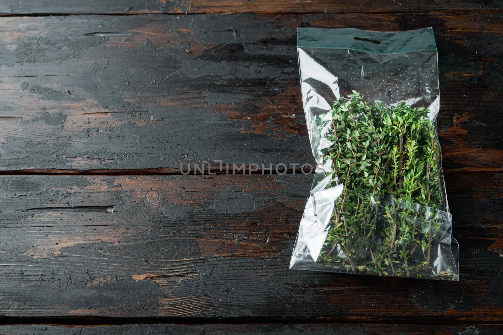 Fresh juicy Thyme in market pack set, on dark wooden background , with copyspace and space for text