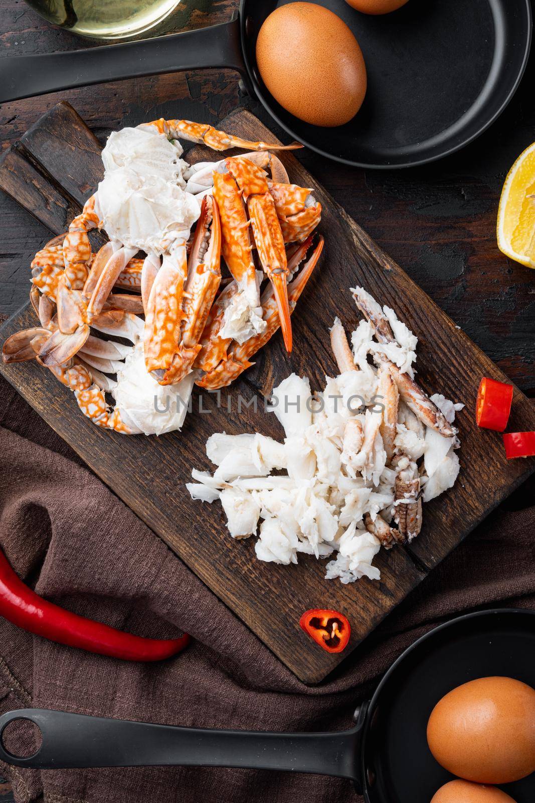 Ingredients for breakfast omelette with crab meat and cheese set, on dark wooden background, top view flat lay