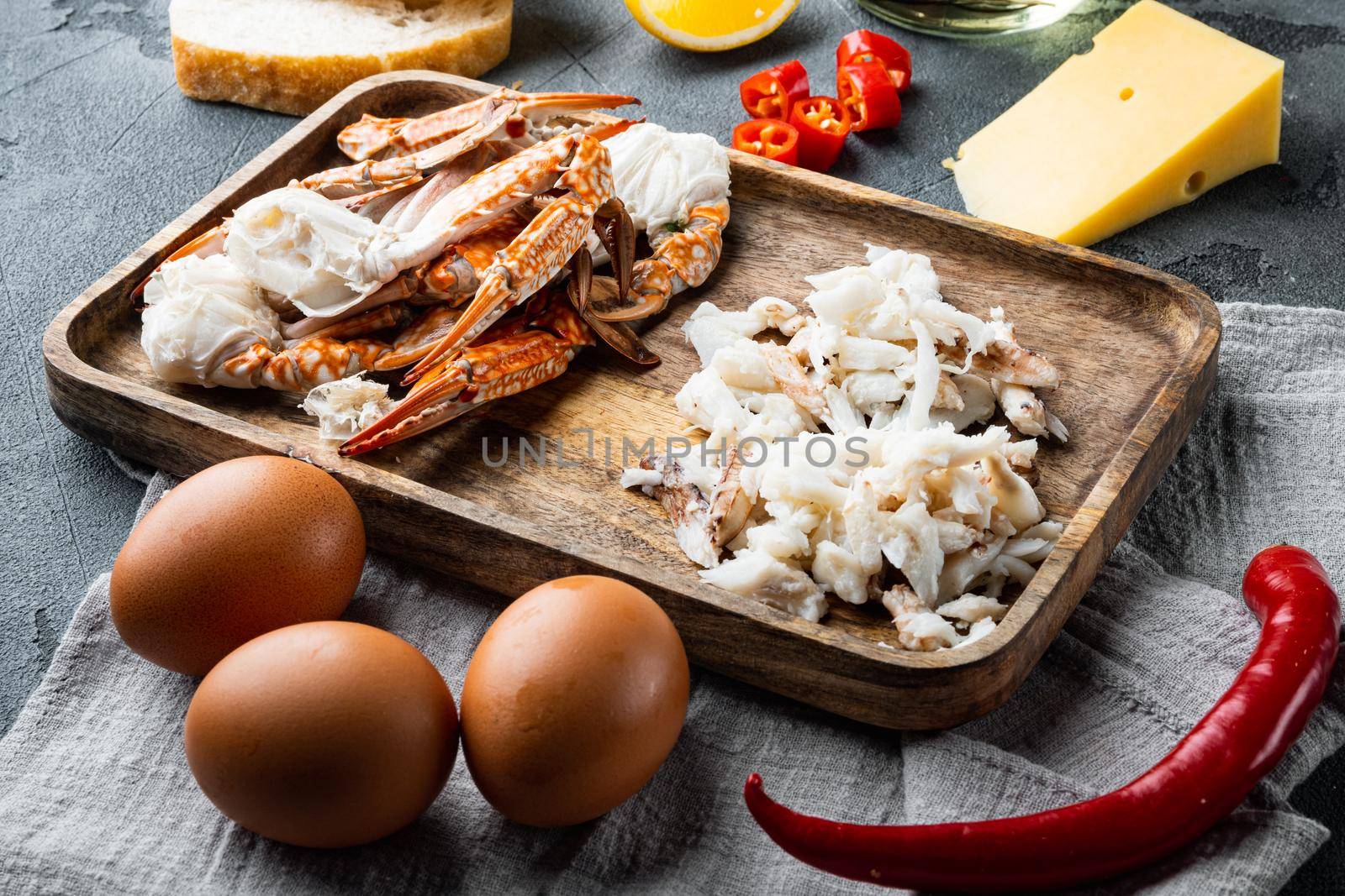 Omelette ingredients with pepper, crab meat, egg, cheese set, on gray background