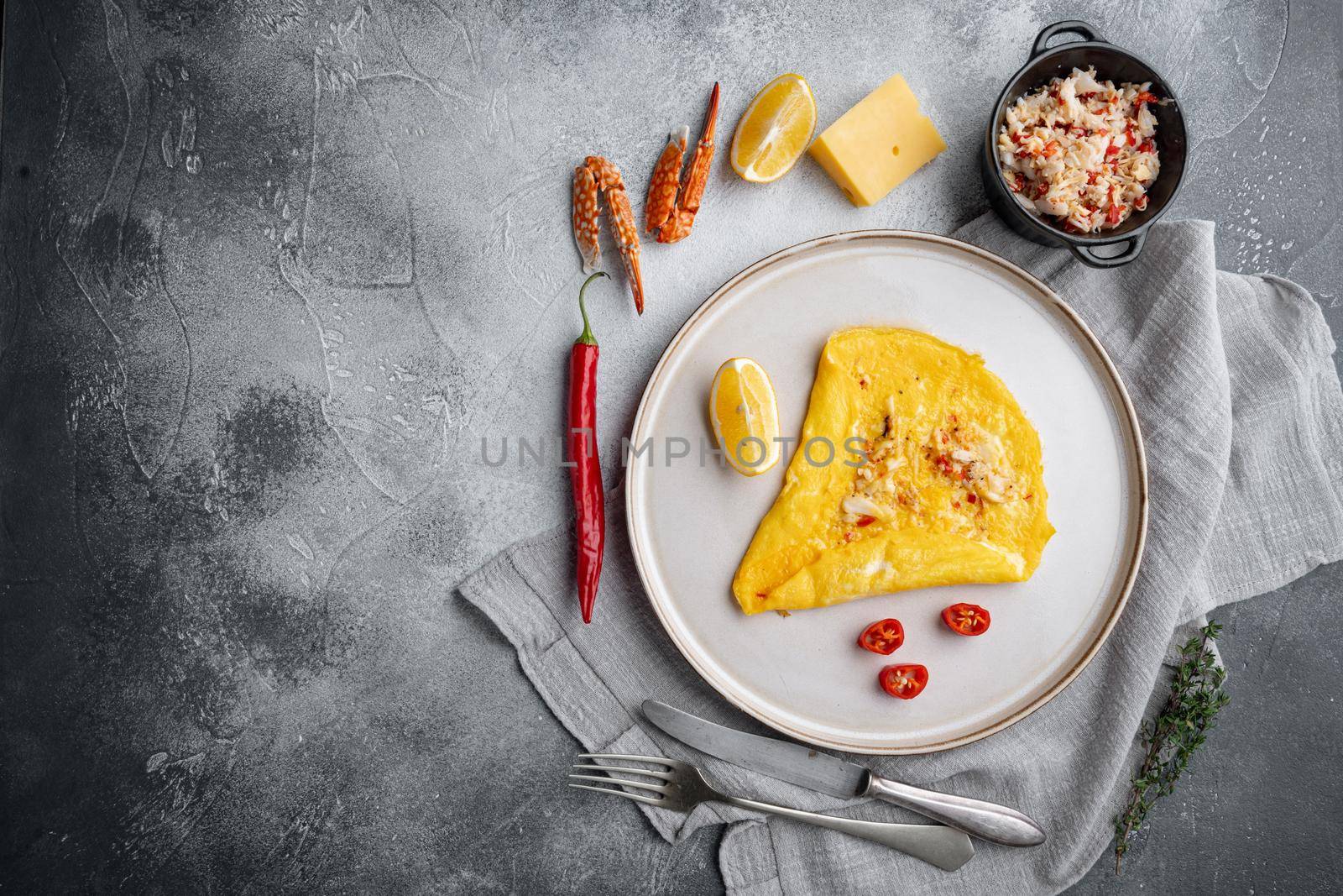 Chilli crab silky omlette, on plate, on gray background, top view flat lay , with copyspace and space for text
