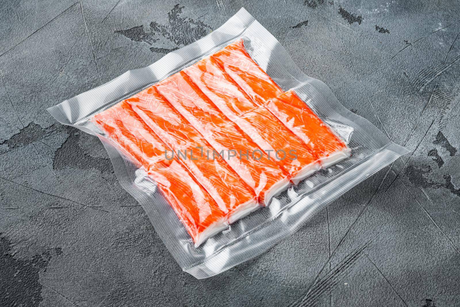 Crab fish meat sticks in vacuum pack set, on gray background