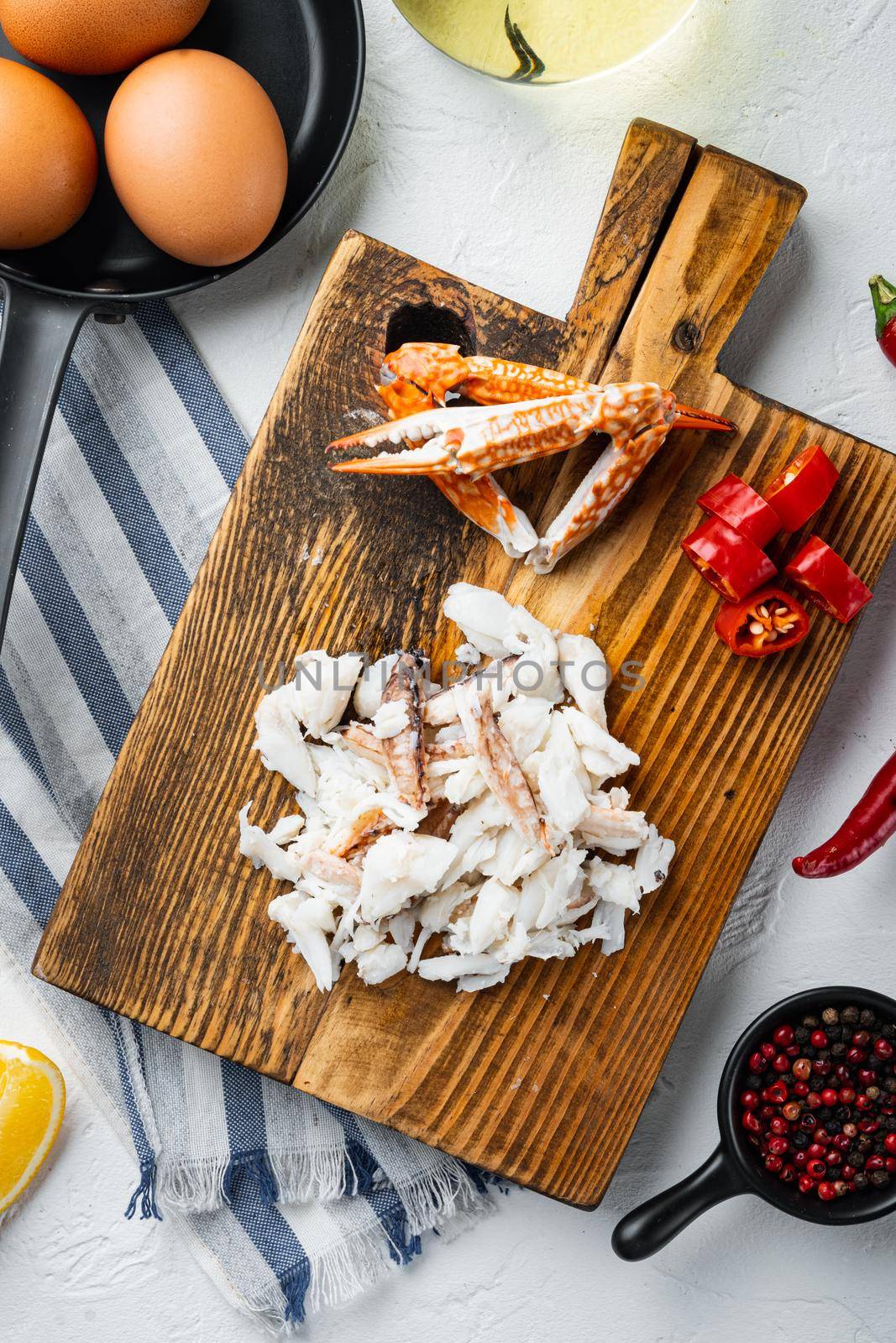 Spanish or Thai omelette ingredient, fresh red chilli, brown and white crabmeat, lemon, Cheddar cheese, eggs set, on white background, top view flat lay