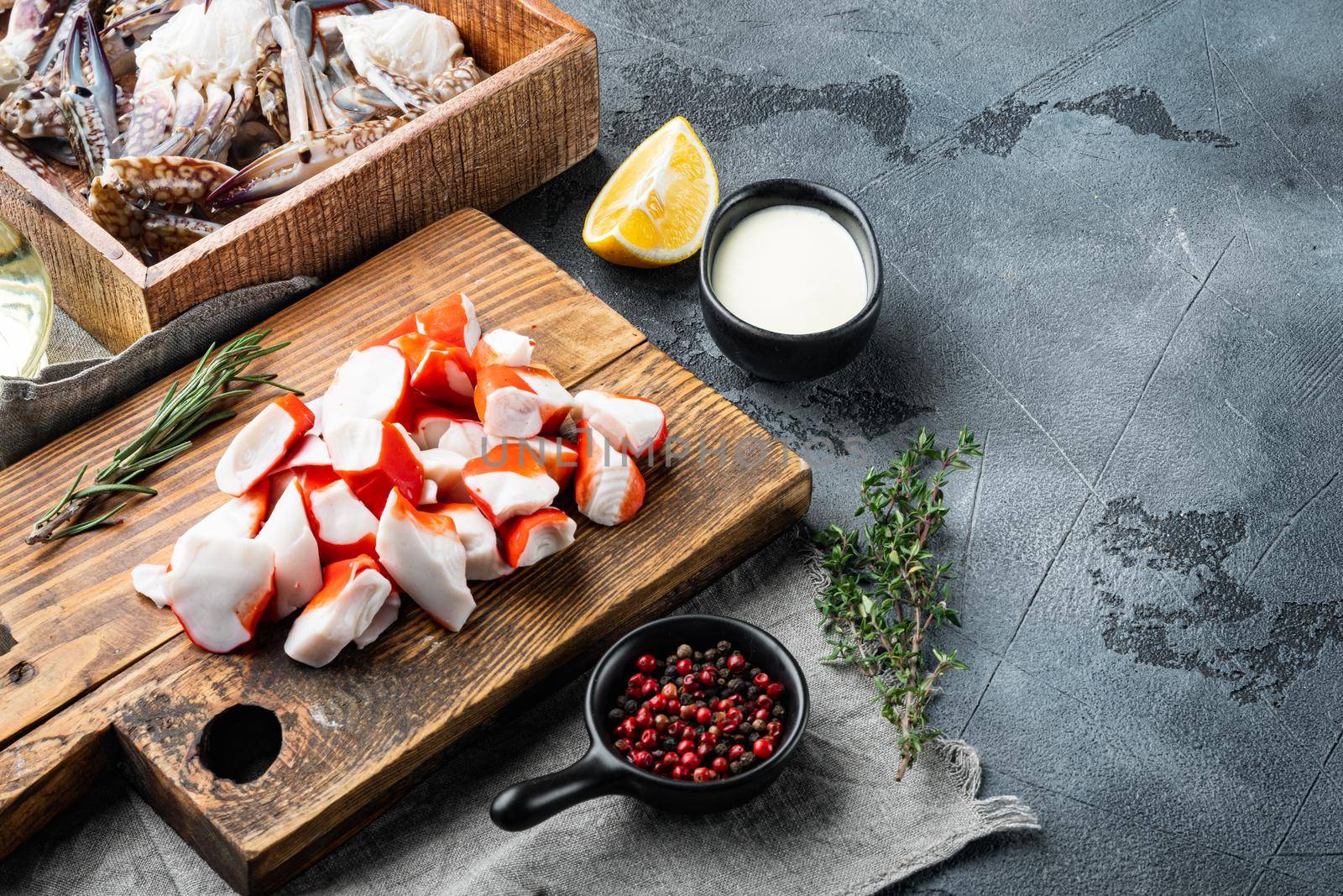 Crab sticks seafood semi finished fish mince with blue swimming crab set, on gray background , with copyspace and space for text