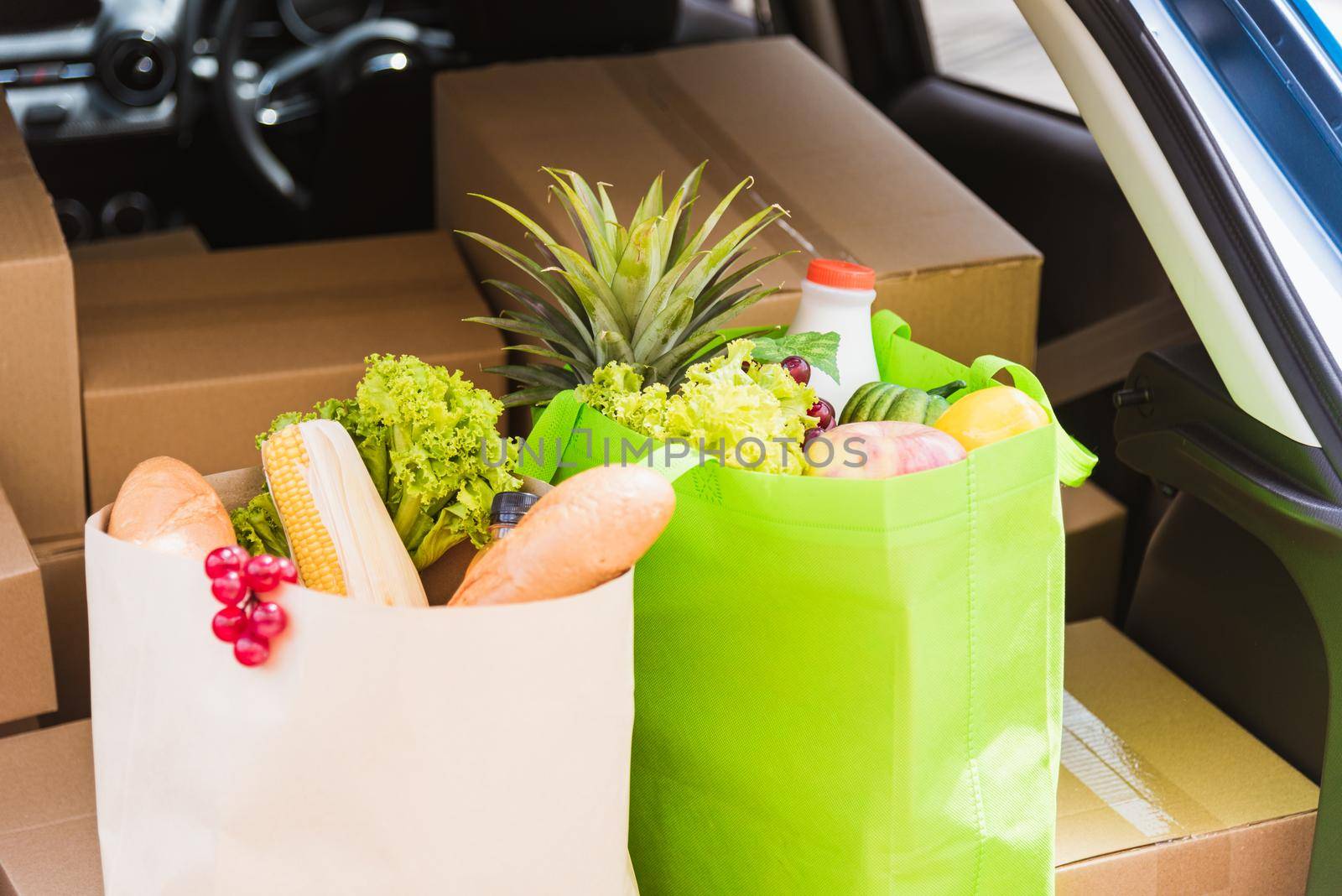 Grocery service giving fresh vegetables and fruits and food in green cloth bag and wooden basket on the back car ready delivery to send woman customer