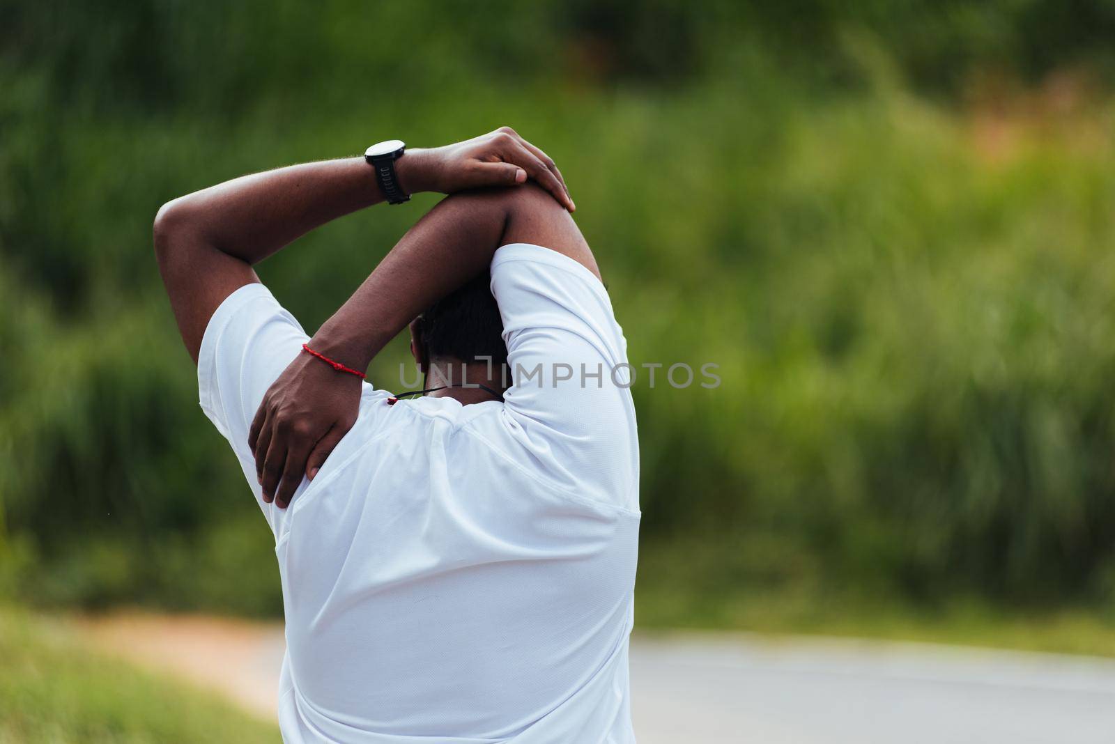 sport runner black man athlete warming up doing stretch arms by Sorapop
