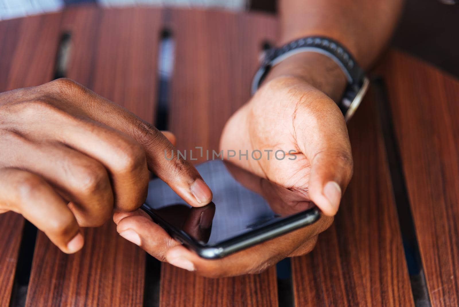 man person holding a modern smart phone and touching a finger to blank screen by Sorapop