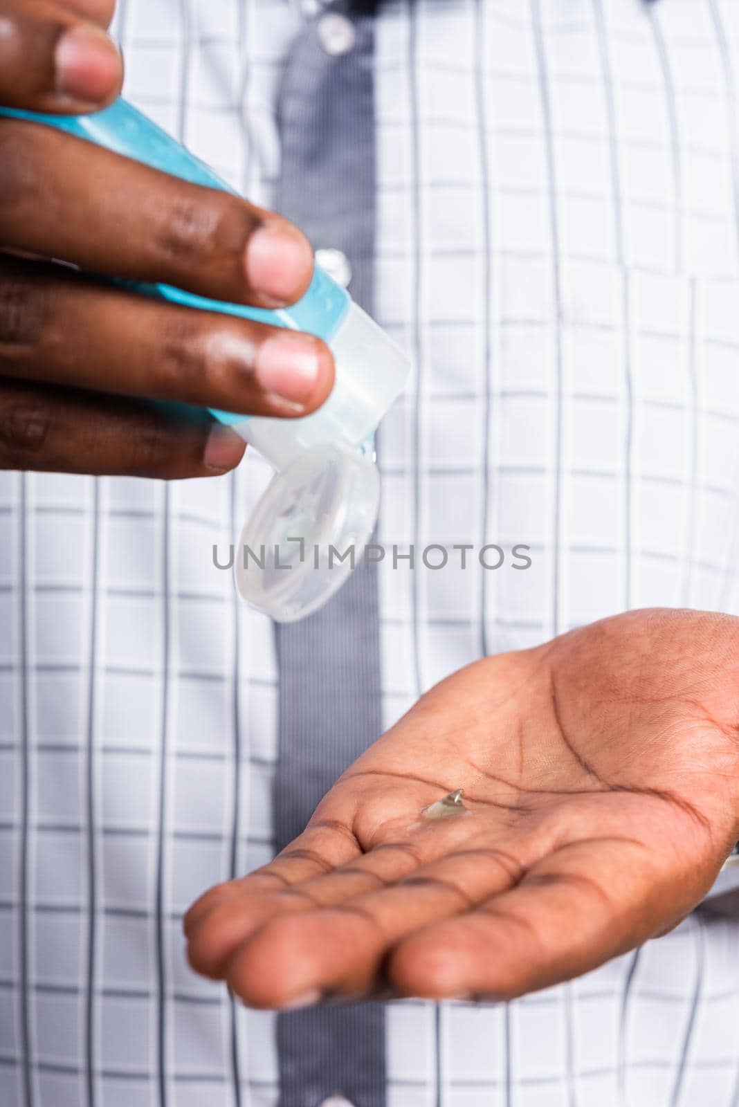 Closeup Asian black man wearing protective face mask  use sanitizer gel face clean his hand, hygiene prevention COVID-19 virus or coronavirus protection concept isolated on white background
